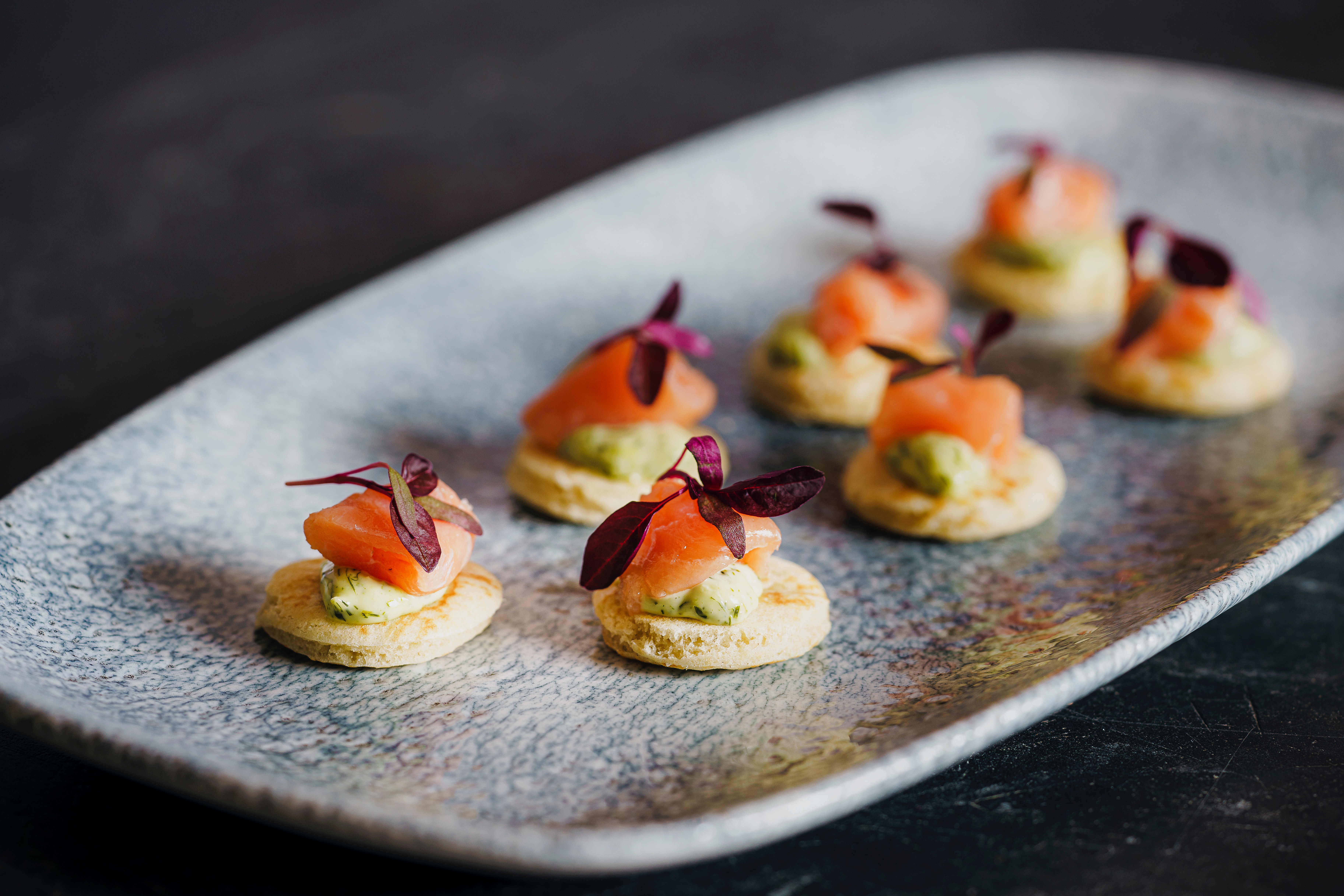 smoked salmon canape in a grey plate